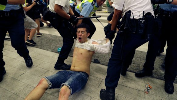 Police drag a protester away.