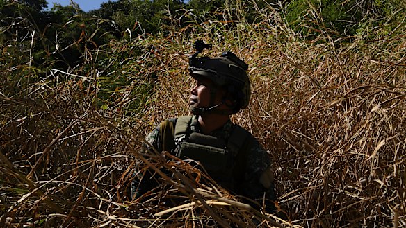 A marine special forces captain who fought in Marawi sits in the grass before training. 