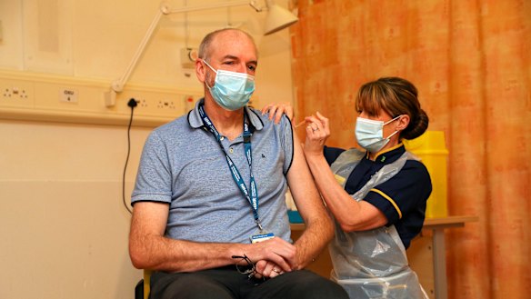Professor Andrew Pollard, the director of the Oxford Vaccine Group, receives the jab given his status as a frontline health worker. 