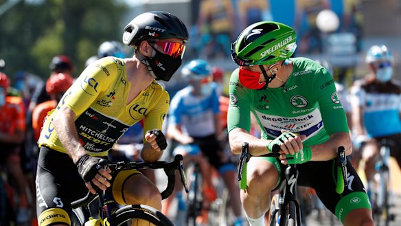 Britain's Adam Yates wearing the overall leader's yellow jersey speaks with Ireland's Sam Bennett, wearing the best sprinter's green jersey at the start of the sixth stage of the Tour de France.