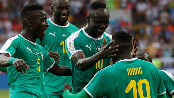 On top: Mbaye Niang is congratulated after grabbing Senegal's second goal.