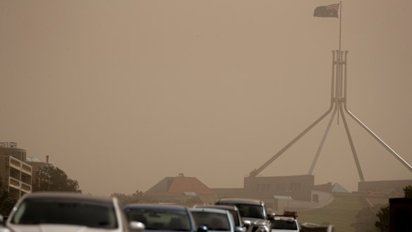 Strong winds blanket Parliament House in dust on Tuesday afternoon. 