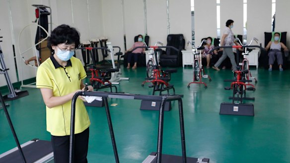 An employee disinfects a treadmill at the Ryugyong Health Complex in Pyongyang, North Kore.
