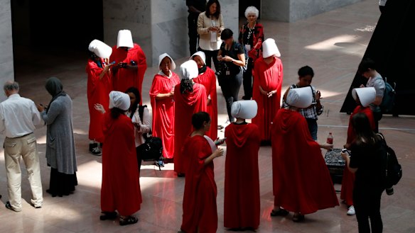 Demonstrators protesting against Supreme Court nominee Brett Kavanaugh, wear costumes from "The Handmaid's Tale". 