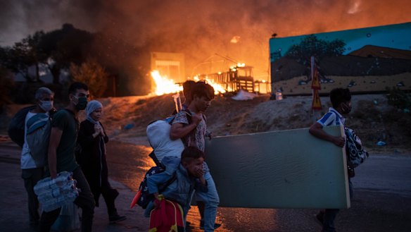 Migrants flee from the Moria refugee camp during a second fire, on the north-eastern Aegean island of Lesbos, Greece.