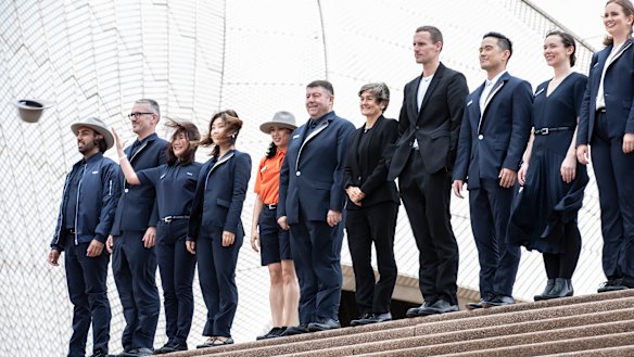 Sydney Opera House CEO Louise Herron and designer Dion Lee (centre) pose for a photograph with staff at the unveiling of the Dion Lee uniform collection in Sydney.
