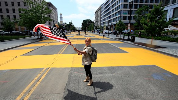 Beth Shafa waves an American flag near the White House.
