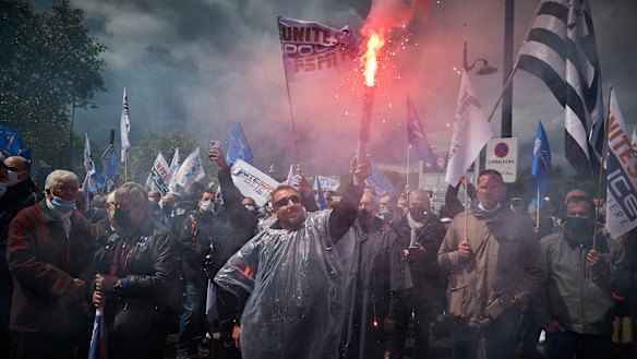 Raw emotions: Police officers demonstrate outside the French Parliament.