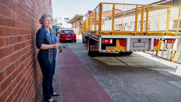 A truck backs up along an easement adjoining Karen Paxton's small business in Fyshwick. The valuation on her block went up 300 per cent in 2016-17, affecting her business.