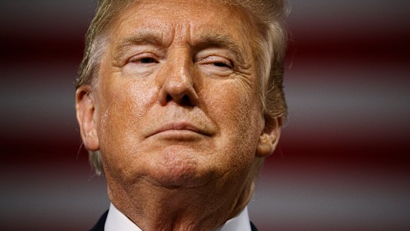 President Donald Trump pauses as he speaks during a campaign rally at Florida State Fairgrounds Expo Hall.
