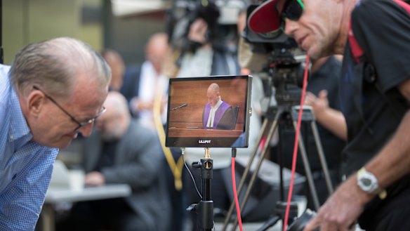 Michael Advocate (left) listens to the sentencing outside of court. 
