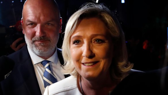 Far-right National Party leader Marine le Pen, escorted by her bodyguard Thierry Legier, after she declared victory in the European Parliament election over pro-EU French President Emmanuel Macron.