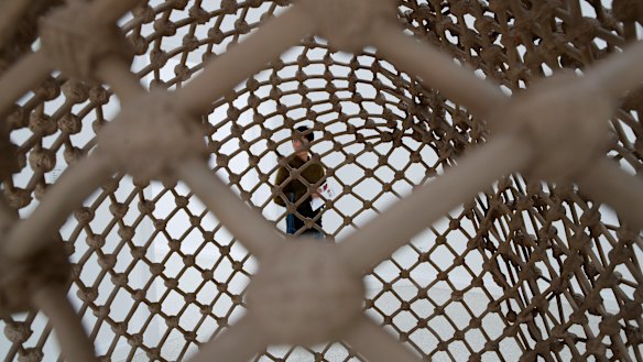 A man looks the Aso Oke sculpture part of "Liberty" installation by artist Martin Puryear, at the Venice Biennale's US pavilion