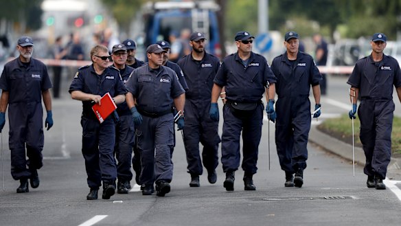 Police officers search the area near the Masjid Al Noor mosque after the terror attack in Christchurch.