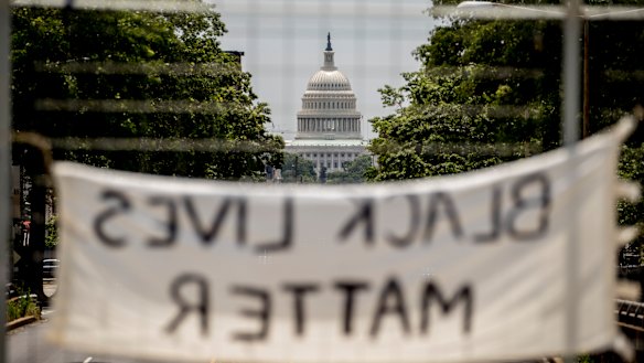 The dome of the US Capitol is visible as a sign that reads "Black Lives Matter" hangs on an overpass on North Capitol Street in Washington.