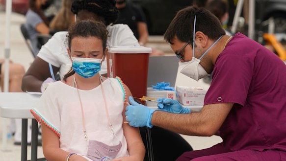 Francesca Anacleto, 12, receives her first Pfizer COVID-19 vaccine shot in Miami Beach, Florida on Tuesday. The state has seen an eight-fold increase in cases since July 4.