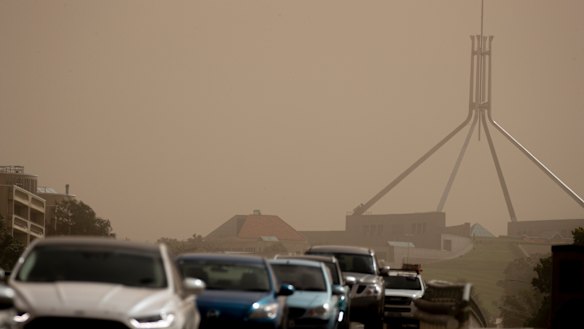 Strong winds blanket Parliament House in dust on Tuesday afternoon. 