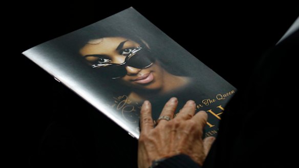 A person holds a program during the funeral service for Aretha Franklin.