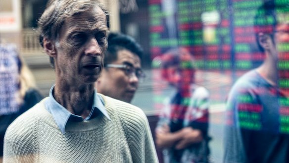 Pedestrians take in the sharp falls on Monday as the ASX 200 endured its second-biggest one day fall in history.