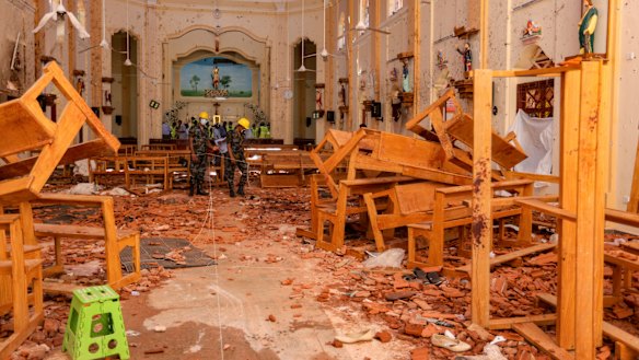 Sri Lankan soldiers inspect the damage inside St. Sebastian's Church where a bomb blast took place in Negombo, Sri Lanka.