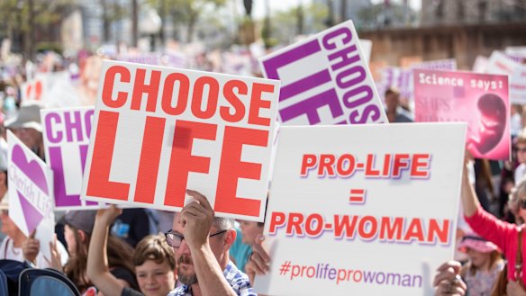 Protesters hold placards during a pro-life rally in Brisbane on Saturday.