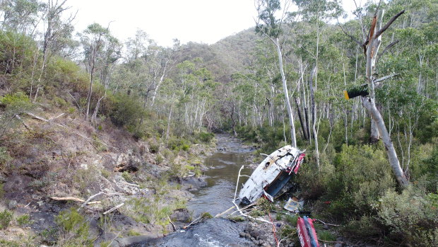 The wreckage of a UH-1H helicopter lies in the Yarrangobilly River after it was destroyed in a crash in April.