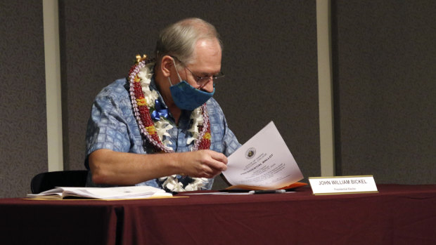 Elector John William Bickel puts his ballot in an envelope at the Hawaii State Capitol after voting for President-elect Joe Biden in the Electoral College in Honolulu on December 14.