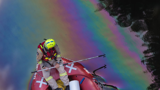 Fire crews mop up an oil spill on The Yarra river, near the Barkers Road bridge in Kew.