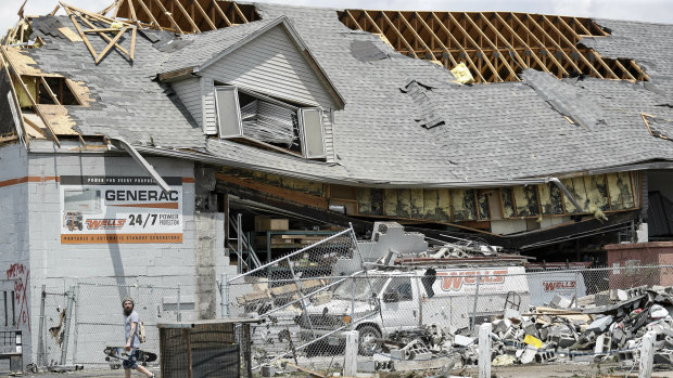 Pedestrians pass along storm debris in Dayton, Ohio.