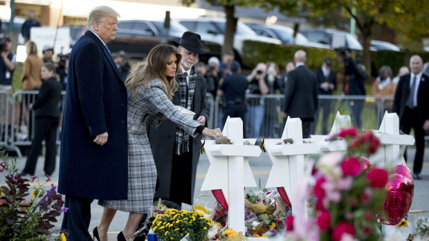 First lady Melania Trump, Donald Trump, and Rabbi Jeffrey Myers, right, at a memorial for those killed at the Tree of Life synagogue.