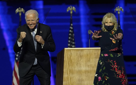 President-elect Joe Biden and wife Jill Biden gesture to supporters after claiming victory.