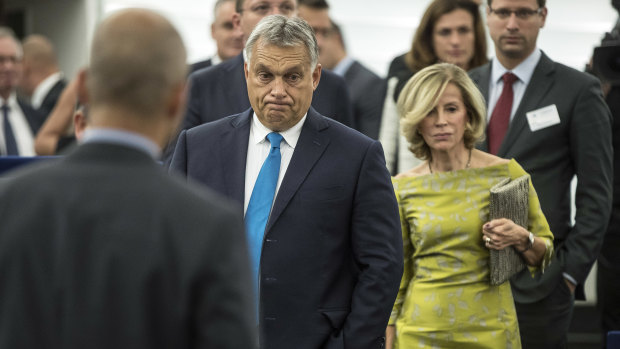Hungary's Prime Minister Viktor Orban, centre, arrives to deliver his speech at the European Parliament in Strasbourg, France.