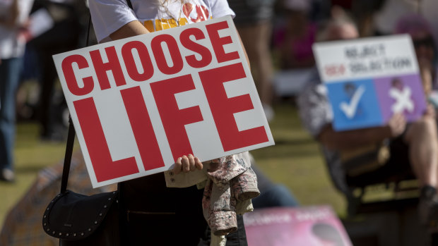 Protesters hold placards during a pro-life rally in Brisbane on September 1.