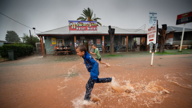 Twins Will and Jack Gorringe, aged 8, playing in floodwaters outside the Windorah pub.