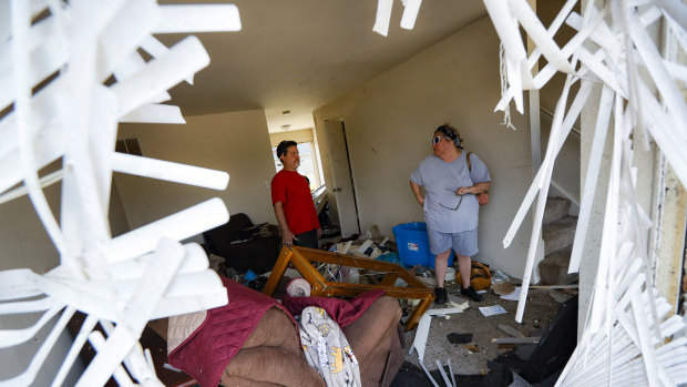 Shaun Vaine, left, and Michele Thrash, right, stand in their destroyed home at the River's Edge apartment complex.