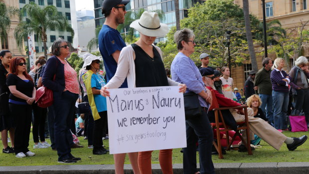 Supporters were holding placards while bowing their heads as they heard stories of refugees.