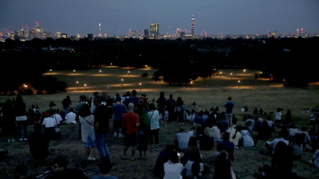 Clouds obscure the view for people gathered to see the 'blood moon', the longest total eclipse of the moon this century, on Primrose Hill in London last week.