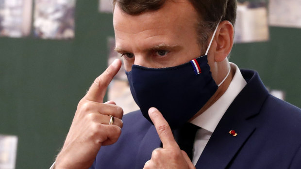 French first: President Emmanuel Macron wear a made-in-France mask while visiting a school. 