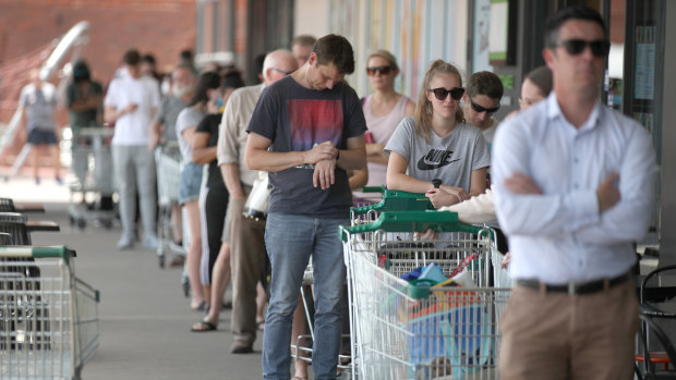 People queuing outside a Woolworths supermarket at West Torrens in Adelaide after the lockdown was announced.