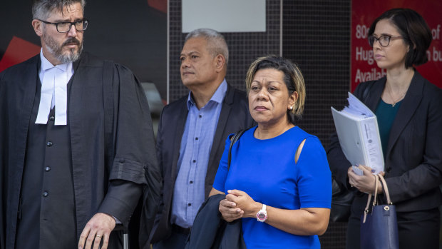 Malavine Pulini (third from left) and Isikeli Feleatoua Pulini (second from left) are seen arriving at the Brisbane District Court in Brisbane on Tuesday.