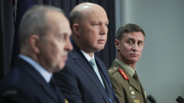 The outgoing Commander of Operation Sovereign Borders, Air Vice-Marshal Stephen Osborne, Minister for Home Affairs Peter Dutton and the incoming Commander of Operation Sovereign Borders, Major General Craig Furini.
