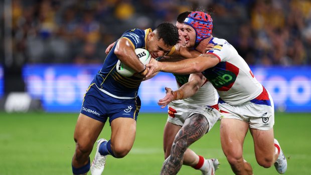 Will Penisini brushes away from Kalyn Ponga and Bradman Best.