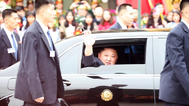 North Korean leader Kim Jong-un waves as his motorcade leaves Vietnam's Dong Dang Station for Hanoi on Tuesday.