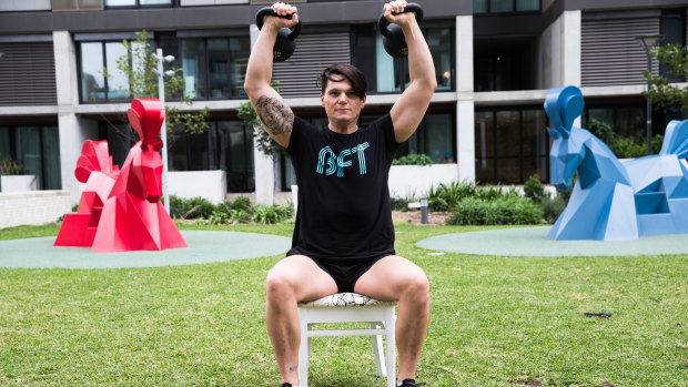 Heaving lifting: Jeremy Tunkuna working out with equipment set up in the courtyard of his Sydney apartment.