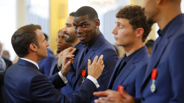 Mind elsewhere: Paul Pogba is awarded of the Legion d'Honneur medal by French president Emmanuel Macron in Paris on June 4.