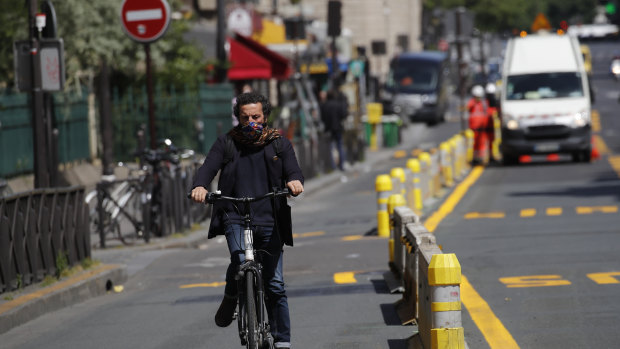 A man rides his bicycle on a new bike lane in Paris.
