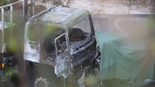 The burnt-out cab of one of the trucks involved in the crash.