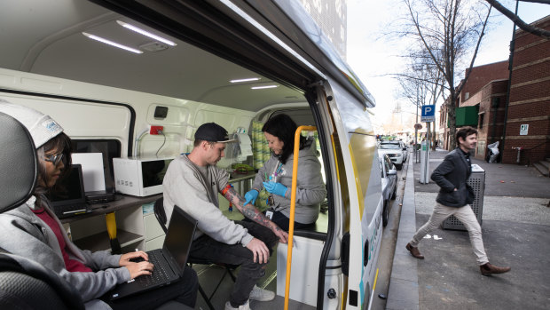 Cohealth street doctor Kate Coles treats Tim Williams in the mobile medical clinic.