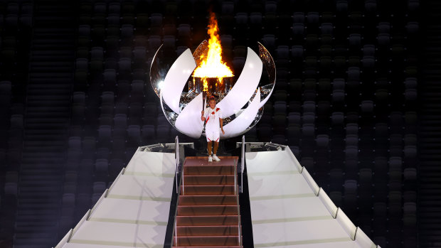 Naomi Osaka of Japan lights the Olympic cauldron with the Olympic torch. 