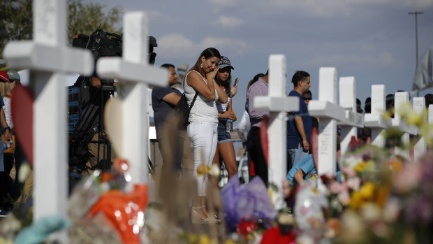 People visit a makeshift memorial at the site of a mass shooting at a shopping complex, in El Paso last month.